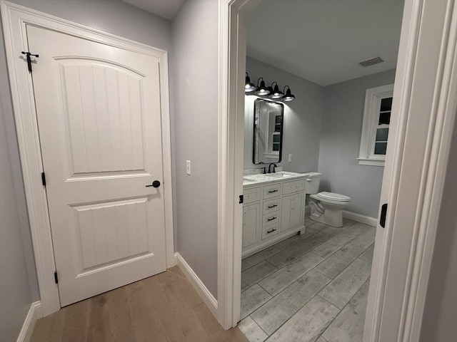 24 Cooper Rd, Webster, MA 01570 - bathroom with wood finished floors, vanity, and baseboards