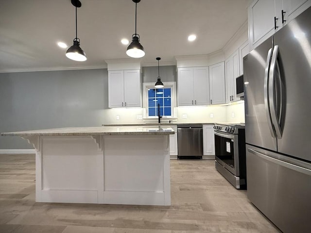 24 Cooper Rd, Webster, MA 01570 - kitchen featuring appliances with stainless steel finishes, crown molding, a center island, a sink, and a kitchen breakfast bar