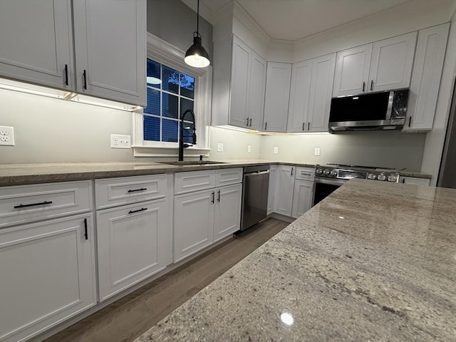 24 Cooper Rd, Webster, MA 01570 - kitchen featuring appliances with stainless steel finishes, a sink, light stone counters, dark wood-style floors, and white cabinetry