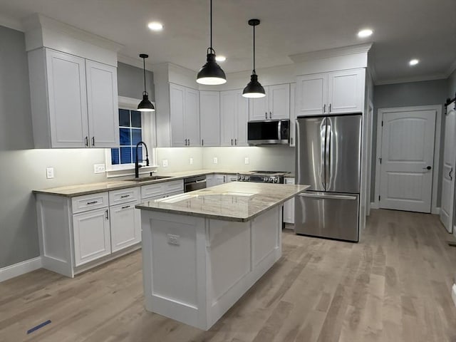 24 Cooper Rd, Webster, MA 01570 - kitchen featuring stainless steel appliances, a sink, ornamental molding, a center island, and light wood-style flooring