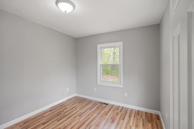 unfurnished room with baseboards, visible vents, and light wood-style flooring