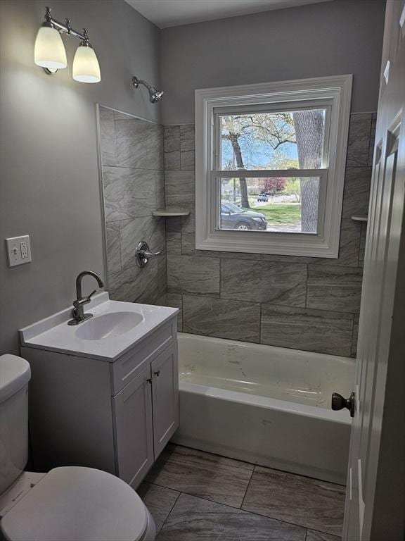 bathroom with vanity, toilet, and shower / washtub combination