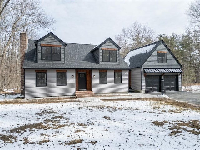 view of front of property featuring an outbuilding and roof with shingles