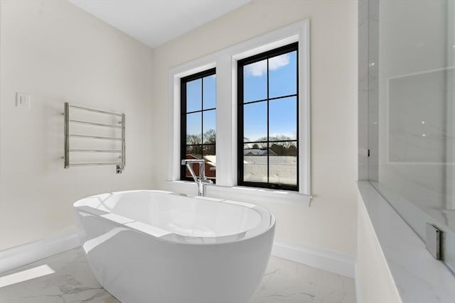 bathroom with radiator and a tub to relax in