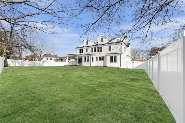 rear view of property featuring a lawn