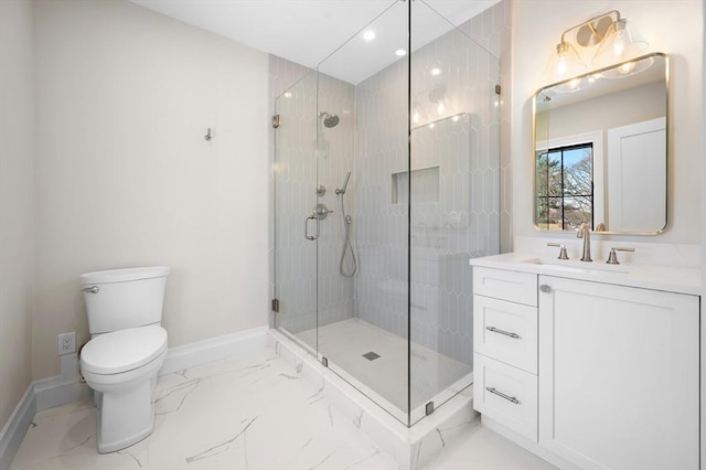 bathroom with walk in shower, vanity, and toilet