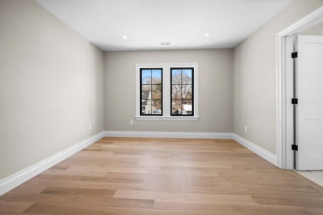 spare room featuring light hardwood / wood-style flooring