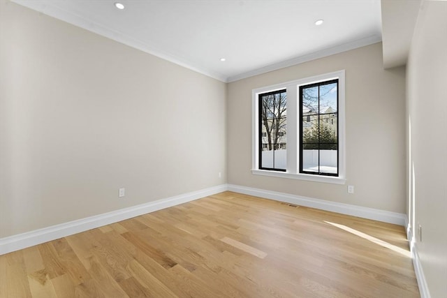 unfurnished room with crown molding and light wood-type flooring