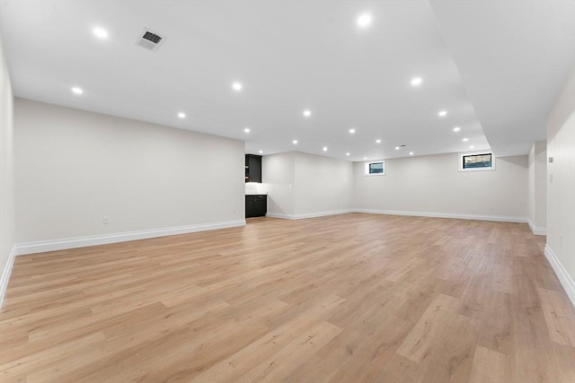 basement with light hardwood / wood-style floors