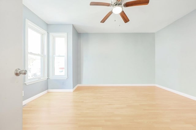 spare room featuring ceiling fan and light hardwood / wood-style flooring