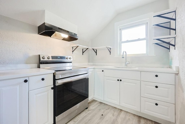 kitchen with lofted ceiling, sink, white cabinets, stainless steel range with electric stovetop, and light hardwood / wood-style floors