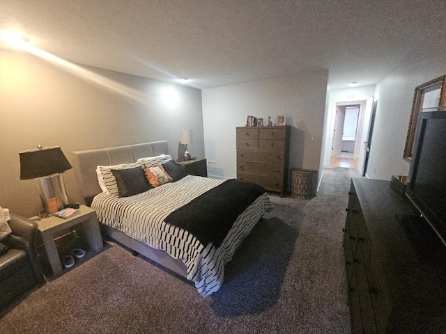 carpeted bedroom featuring a textured ceiling