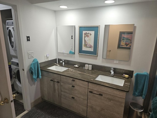 bathroom featuring vanity and stacked washer / drying machine