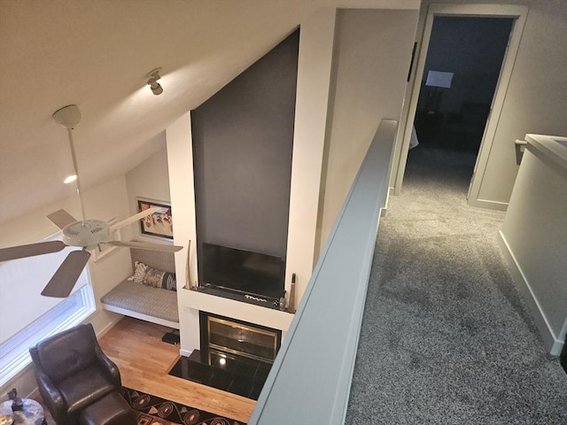 interior space featuring lofted ceiling and ceiling fan