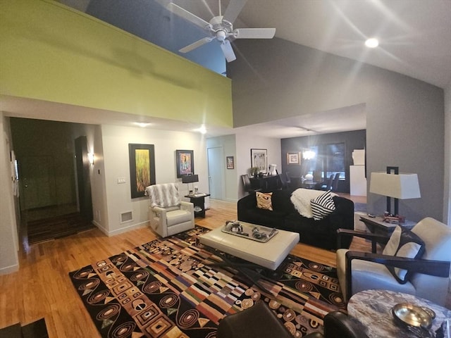 living room with wood-type flooring, high vaulted ceiling, and ceiling fan