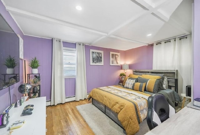 bedroom with wood-type flooring, beam ceiling, baseboard heating, and recessed lighting