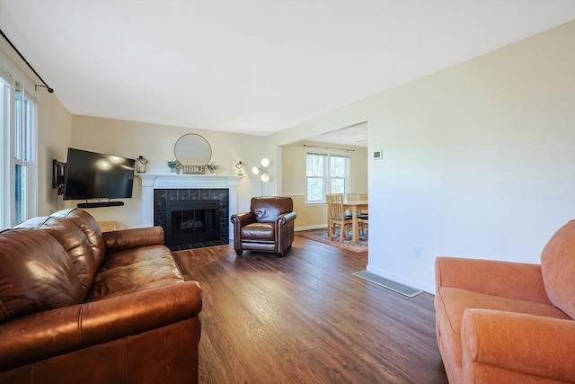 living room with dark hardwood / wood-style floors and a fireplace