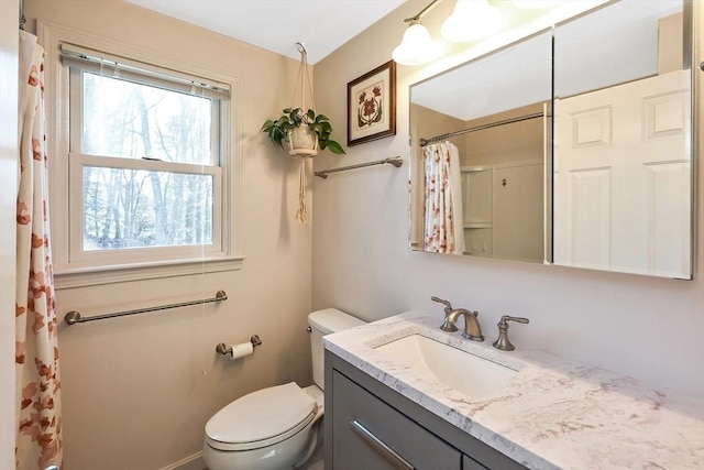 bathroom featuring vanity, toilet, and curtained shower