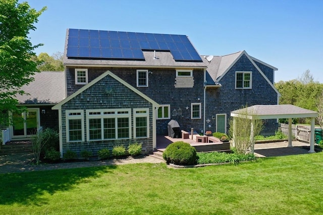 116 Fairview Ln, Plymouth, MA 02360 - rear view of house featuring a yard, solar panels, a deck, and a shingled roof
