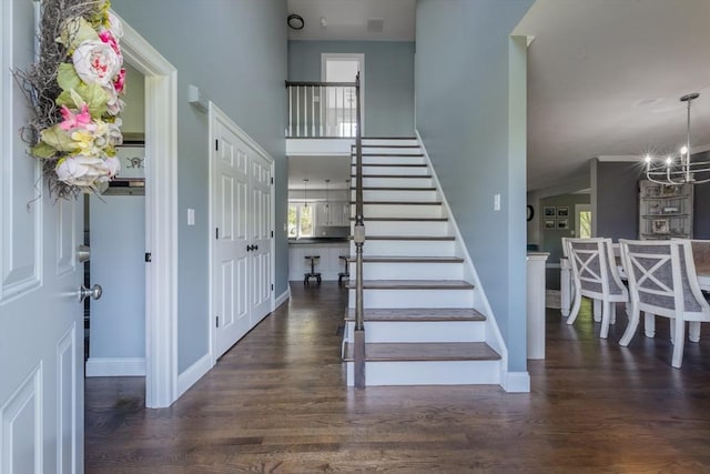 116 Fairview Ln, Plymouth, MA 02360 - staircase with wood finished floors, a chandelier, baseboards, and a towering ceiling