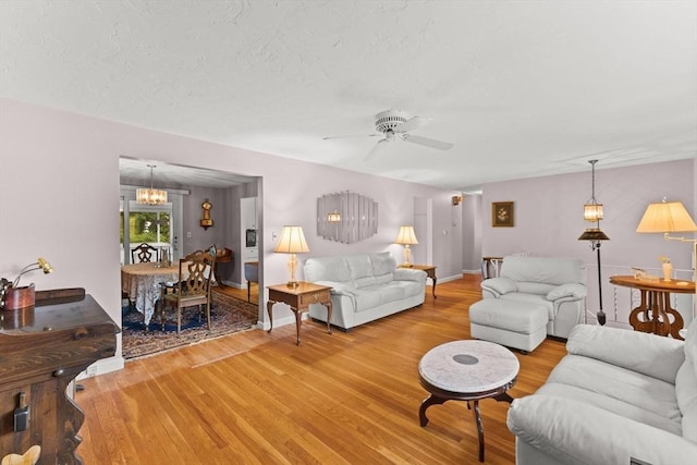 16 Fencourt, Canton, MA 02021 - living room featuring light wood finished floors, a ceiling fan, a chandelier, and baseboards