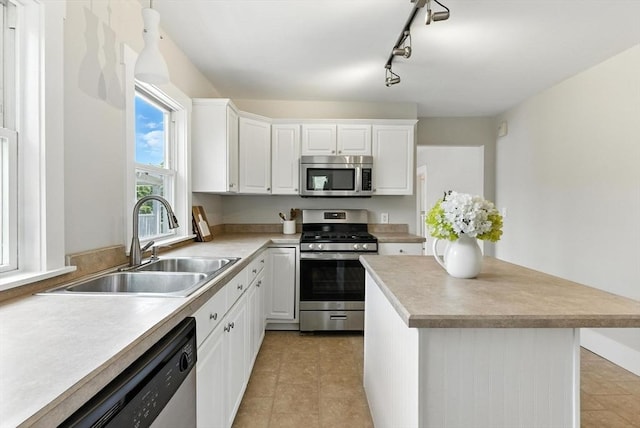 216 Cedar St Unit 3, Somerville, MA 02144 - kitchen featuring stainless steel appliances, white cabinets, light countertops, and light tile patterned flooring