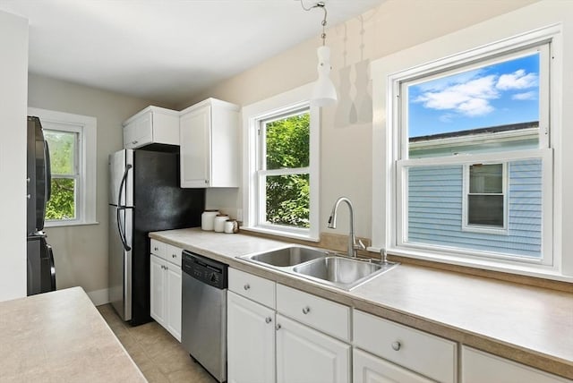 216 Cedar St Unit 3, Somerville, MA 02144 - kitchen featuring stainless steel appliances, white cabinetry, light countertops, and light tile patterned floors