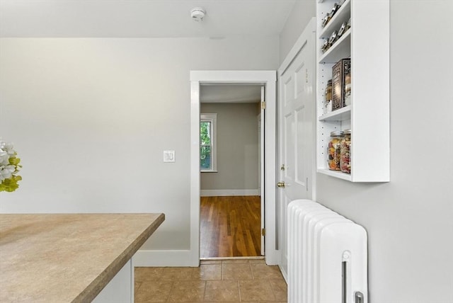216 Cedar St Unit 3, Somerville, MA 02144 - hall with radiator and light tile patterned floors