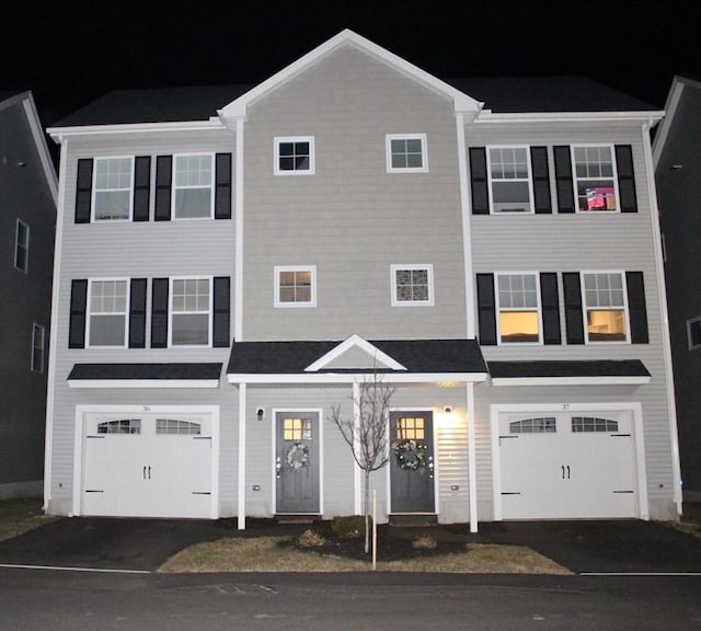 view of property featuring driveway and an attached garage