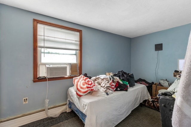 carpeted bedroom featuring baseboard heating and cooling unit