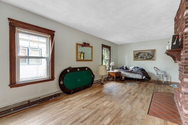 bedroom featuring a fireplace and light hardwood / wood-style flooring