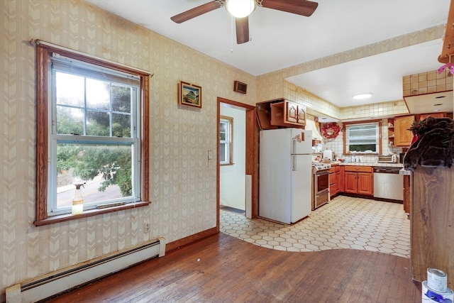 kitchen with ceiling fan, light hardwood / wood-style floors, appliances with stainless steel finishes, and a baseboard radiator