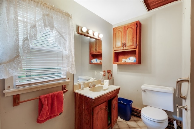 bathroom featuring tile patterned flooring, vanity, and toilet