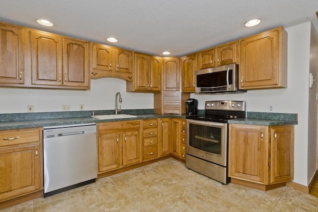 12 Allen St, Chicopee, MA 01020 - kitchen with stainless steel appliances, dark countertops, recessed lighting, and brown cabinets