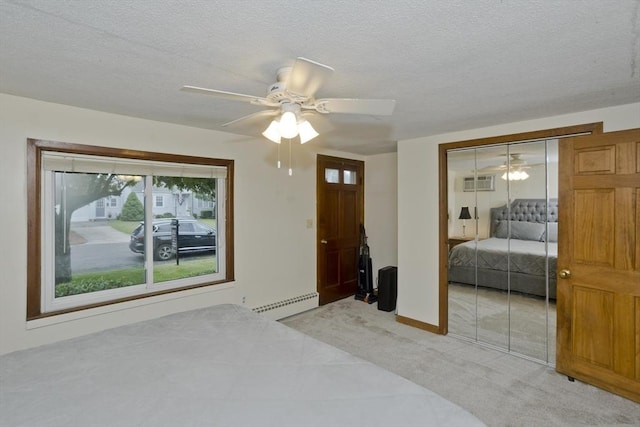 12 Allen St, Chicopee, MA 01020 - bedroom featuring a baseboard heating unit, a closet, an AC wall unit, ceiling fan, and a textured ceiling