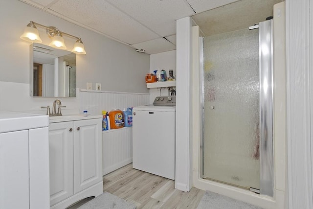 12 Allen St, Chicopee, MA 01020 - full bathroom with washer / dryer, a stall shower, wood finished floors, a paneled ceiling, and vanity