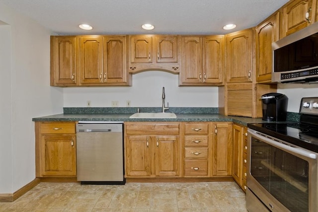 12 Allen St, Chicopee, MA 01020 - kitchen featuring appliances with stainless steel finishes, dark countertops, brown cabinets, and recessed lighting