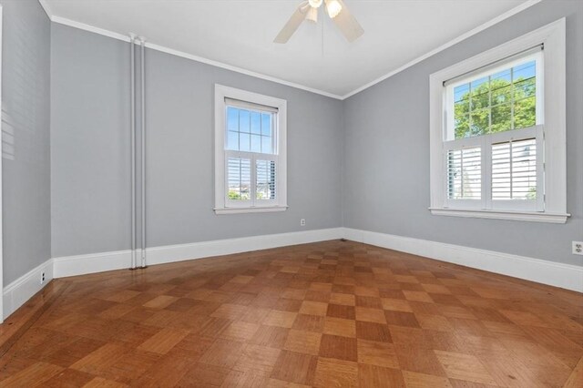 empty room with crown molding, a ceiling fan, and baseboards