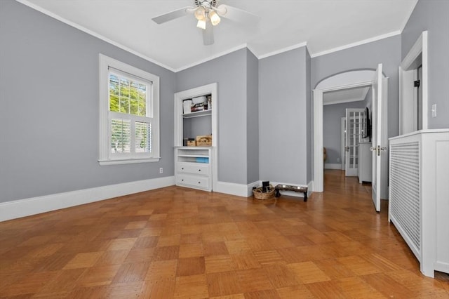 unfurnished room with ceiling fan, ornamental molding, and baseboards