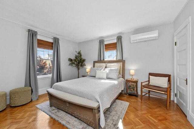 bedroom with a wall unit AC, multiple windows, and baseboards