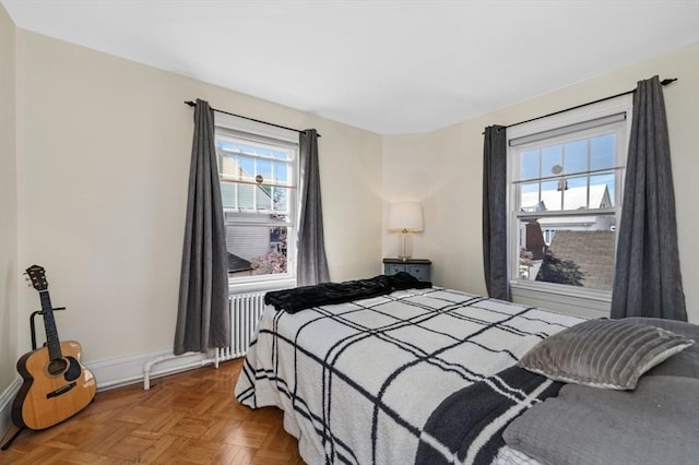 bedroom with radiator heating unit and baseboards