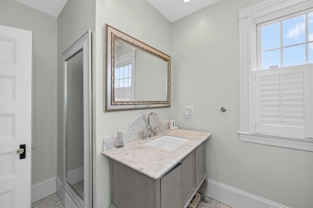 bathroom featuring baseboards and vanity
