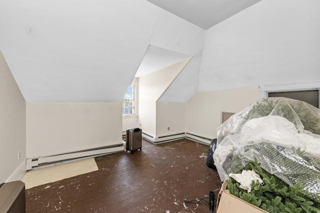 additional living space featuring a baseboard radiator, lofted ceiling, and wood finished floors