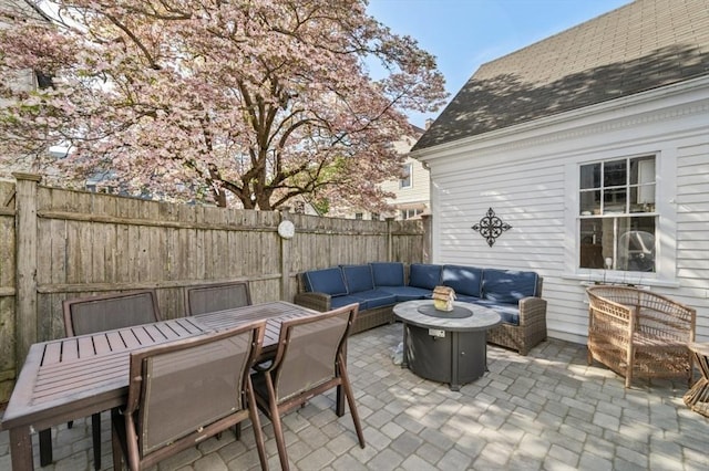 view of patio featuring an outdoor hangout area and fence