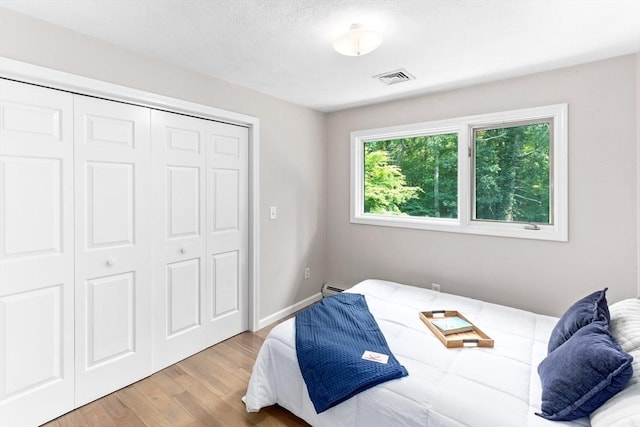 11 Running Stream Rd, Rehoboth, MA 02769 - bedroom with wood finished floors, a closet, and a baseboard heating unit
