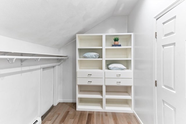 11 Running Stream Rd, Rehoboth, MA 02769 - walk in closet featuring lofted ceiling, wood finished floors, and a baseboard heating unit