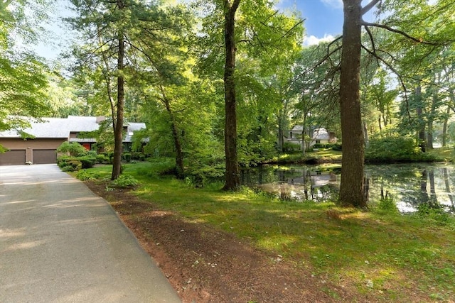 11 Running Stream Rd, Rehoboth, MA 02769 - view of yard with a water view, a garage, and driveway