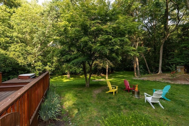 11 Running Stream Rd, Rehoboth, MA 02769 - view of green lawn featuring a wooden deck, an outdoor fire pit, and a wooded view