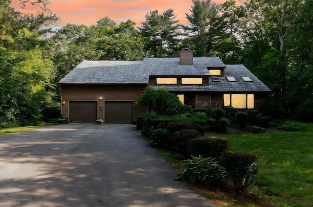 11 Running Stream Rd, Rehoboth, MA 02769 - view of front of home with driveway, a chimney, an attached garage, and view of wooded area