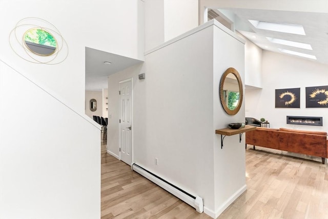 11 Running Stream Rd, Rehoboth, MA 02769 - hallway featuring a baseboard radiator, high vaulted ceiling, a skylight, and light wood finished floors